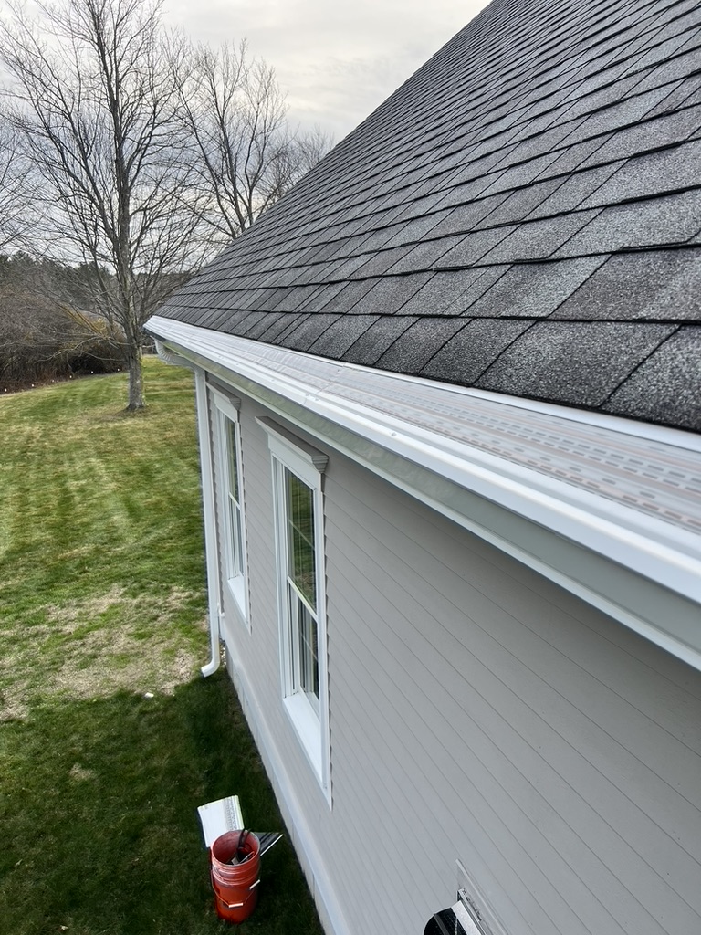 White New England home with full seamless white gutter run